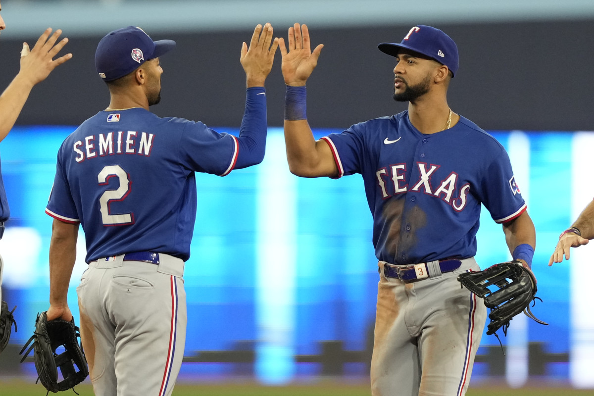 Sep 11, 2023; Toronto, Ontario, CAN; Texas Rangers second baseman Marcus Semien (2) and center fielder Leody Taveras (right) celebrate a win over the Toronto Blue Jays during the ninth inning at Rogers Centre. Mandatory Credit: John E. Sokolowski-USA TODAY Sports